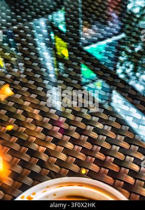 Reflections on a Brown woven resin wicker table Stock Photo