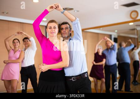 Woman and man practicing bachata in dance class Stock Photo