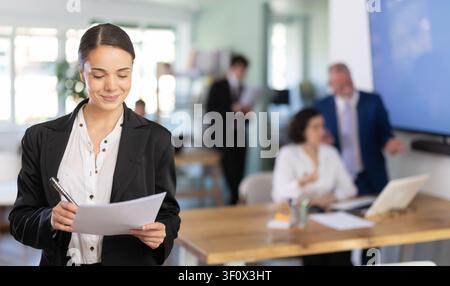 Young woman taking notes in document Stock Photo