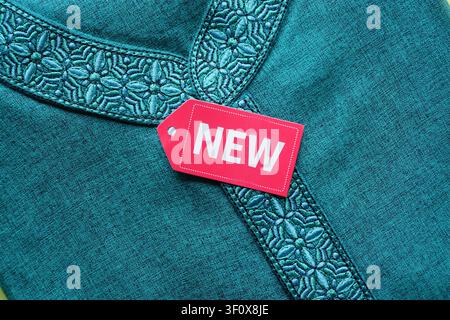 Crafted fabric featuring delicate embroidery and a new tag Stock Photo