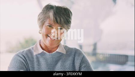 Wellness, portrait or senior woman in home with smile, positive attitude or optimistic for weekend break. Wellbeing, space or elderly person with good Stock Photo