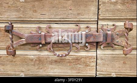 Close-Up of Antique Door Lock with Ornate Wrought Iron Details in the Engadin, Switzerland Stock Photo