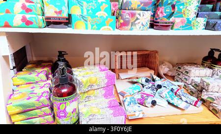 Farm shop gift display with botanical hand soaps, liquid hand wash bottles and tubes of hand cream on wooden shelves Stock Photo