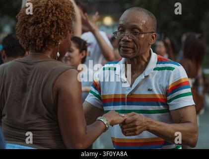 Happy older man dancing with woman outdoors Stock Photo