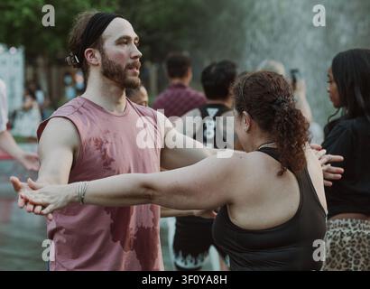 People dancing together in an outdoor class Stock Photo