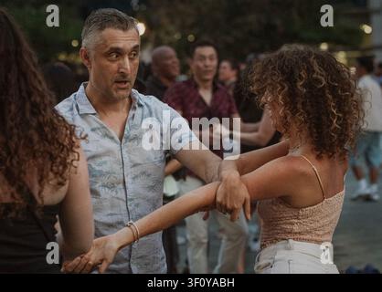 Man and woman dancing salsa at an outdoor party Stock Photo