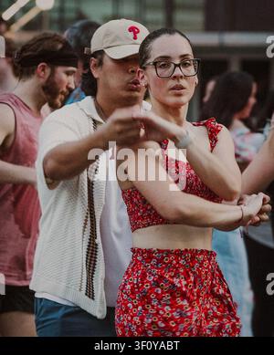 Young woman in glasses learning partner dance moves Stock Photo