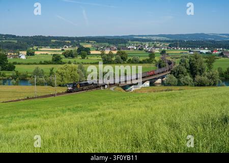 193 656 passen through Huenenberg, ZG with a southbound freight train. Stock Photo