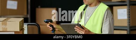 Header of adult woman scanning package barcode and checking tablet in warehouse, managing inventory and order fulfillment. Useful for logistics, supply chain, retail operations marketing Stock Photo