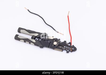 Wire Stripper Tool Stripping Red and Black Electrical Wires Stock Photo