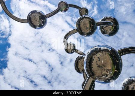 Reflective Chrome Sphere Sculpture Against a Blue Sky in London Stock Photo