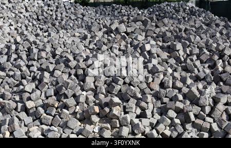 Large heap of porphyry cubes. They are used as construction materials for pavement. Background and texture. Stock Photo