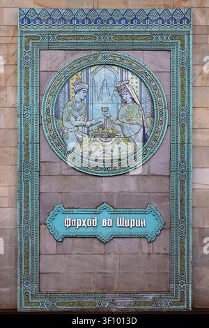 Ornate ceramic tile panel depicting Farhod and Shirin at Alisher Navoiy metro station in Tashkent. Turquoise and gold tilework frames a circular medal Stock Photo