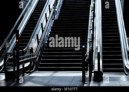 Symmetrical Escalators and Central Staircase in Modern Architectural Interior Stock Photo