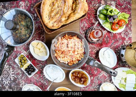 A table covered with a wide array of delicious and refreshing food and drinks, set for a lively gathering of people. Stock Photo