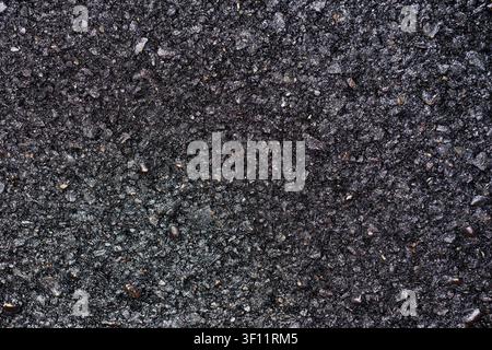 Dark black background created with an asphalt road. Abstract texture concept of public works. Stock Photo