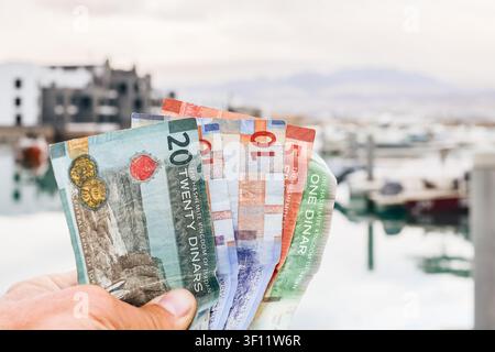 Jordanian dinar banknotes in hand, economy finance cash concept, real estate investment background. Ayla. Holidays in Jordan, red sea vacation, proper Stock Photo