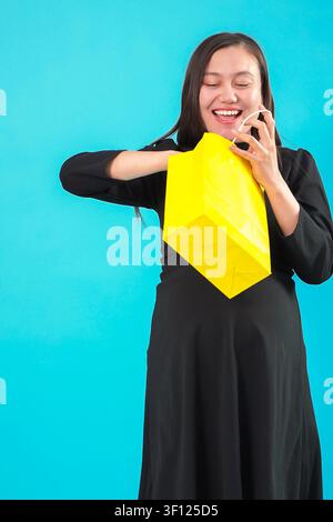 Pregnant woman holding documents and using mobile smartphone Stock Photo