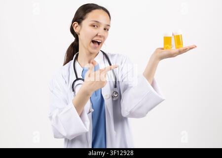 Smiling female pharmacist showing boxes of medicine and treatments Stock Photo