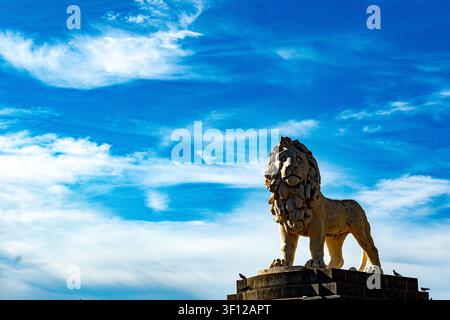 Stone lion statue on Westminster Bridge against blue sky, London, England Stock Photo
