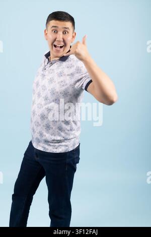 Confident young man smiling and pointing his finger directly forward Stock Photo