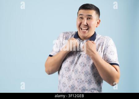 Young man expressing fear and shock holding hands defensively Stock Photo