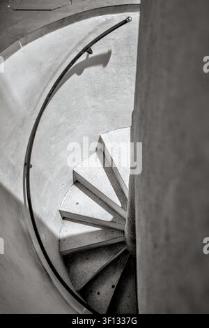 Black-and-white view looking down a spiral staircase inside Bratislava Castle, Slovakia. Stock Photo