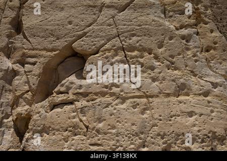 Close up texture of an ancient weathered porous limestone rock wall in Malta. Stock Photo
