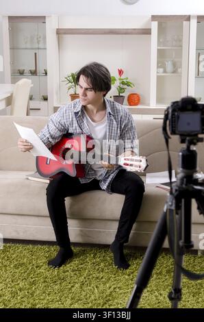 Young guitar player recording video for his blog Stock Photo