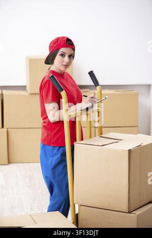 Young female professional mover doing home relocation Stock Photo
