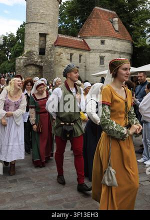 Tallinn, Estonia - 10 July 2026: Tallinn Medieval Days, group in colorful medieval costume walk in a street parade Stock Photo