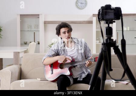 Young guitar player recording video for his blog Stock Photo