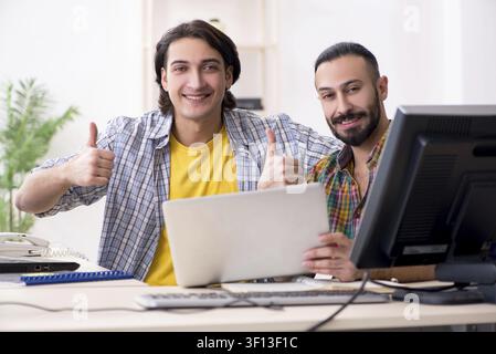 Two it specialists working in the office Stock Photo