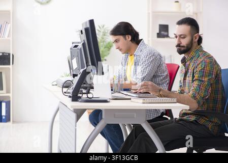 Two it specialists working in the office Stock Photo