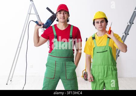 Two workers contractors working indoors Stock Photo