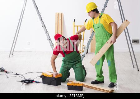 Injured worker and his workmate Stock Photo