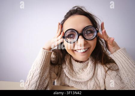 Funny nerd girl working on computer Stock Photo