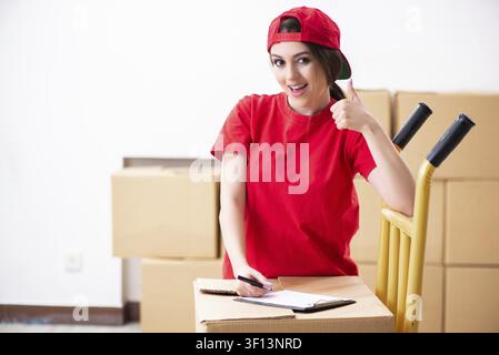 Young female professional mover doing home relocation Stock Photo