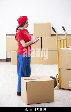 Young female professional mover doing home relocation Stock Photo