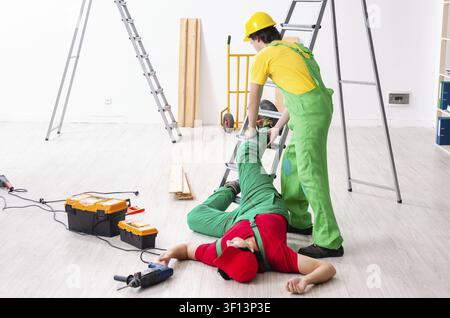 Injured worker and his workmate Stock Photo