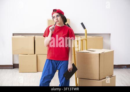 Young female professional mover doing home relocation Stock Photo