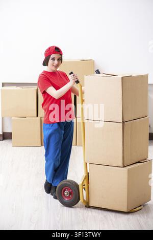 Young female professional mover doing home relocation Stock Photo