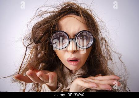 Funny nerd girl working on computer Stock Photo