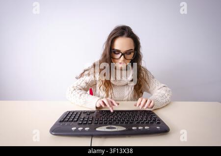 Funny nerd girl working on computer Stock Photo