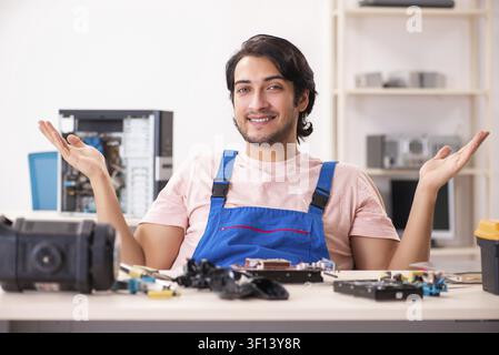 Young male contractor repairing computer Stock Photo