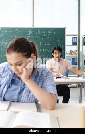 Young students taking the math exam in classroom Stock Photo