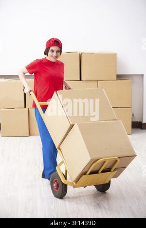 Young female professional mover doing home relocation Stock Photo