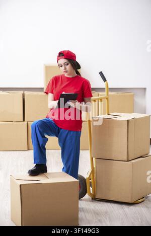 Young female professional mover doing home relocation Stock Photo