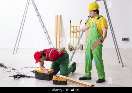 Injured worker and his workmate Stock Photo