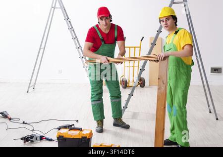 Two workers contractors working indoors Stock Photo